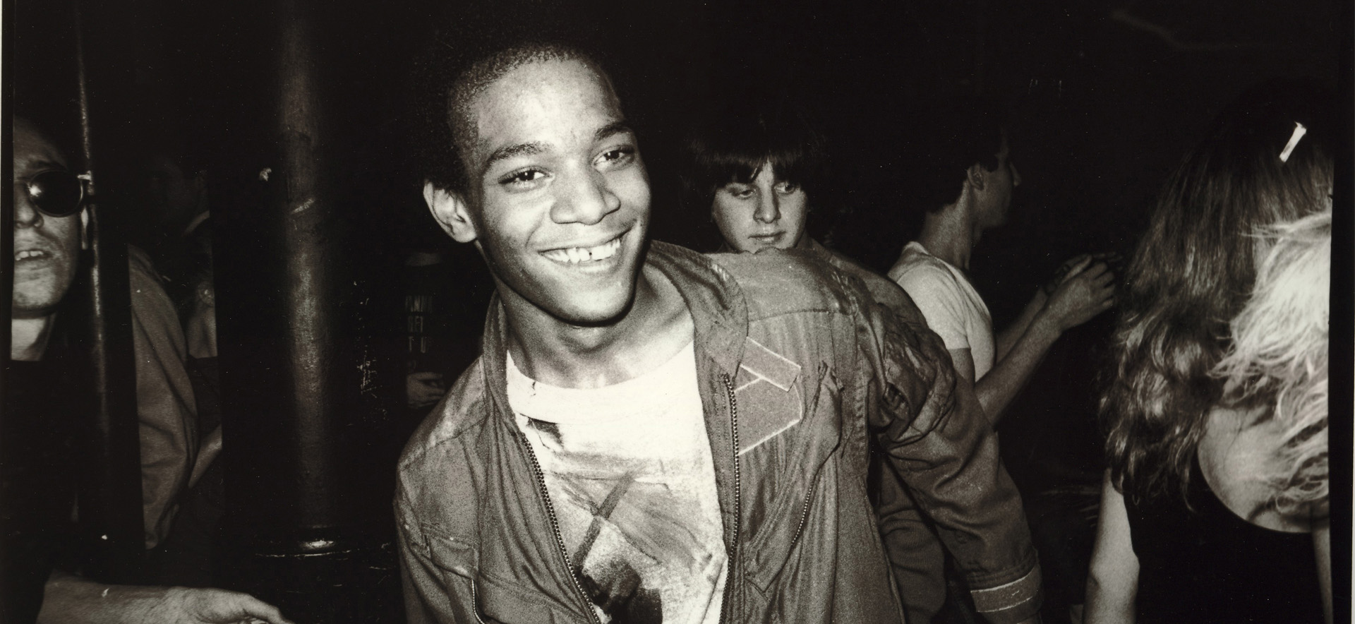 Jean dancing at the Mudd Club with painted t-shirt, 1979 © Nicholas Taylor, © Estate of Jean-Michel Basquiat, Licensed by Aretstar, New York